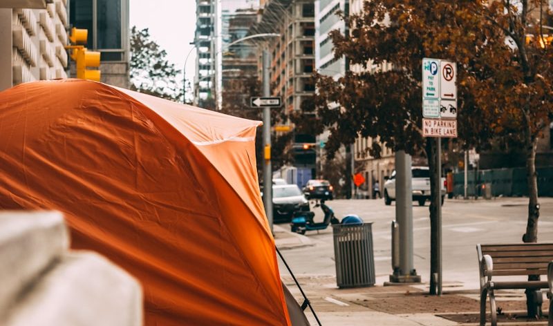 orange umbrella on sidewalk during daytime
